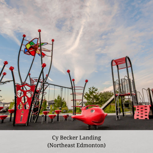 A red playground with kalidiscope sun catcher and blue sky with pillowy clouds in the background
