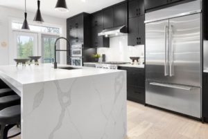 Black cabinetry with marble counters