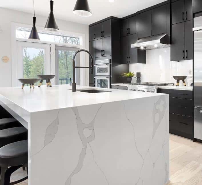 Black cabinetry with marble counters