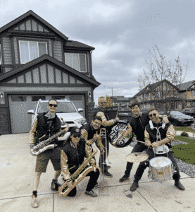 Brass Band poses in front of Desrochers home