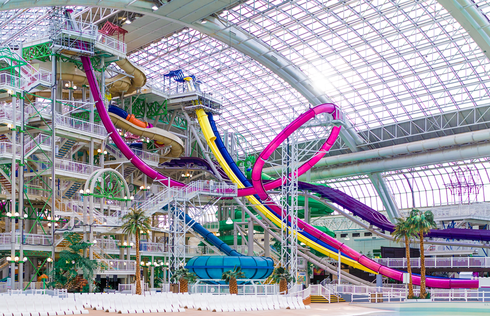 A large indoor waterpark with colourful waterslides